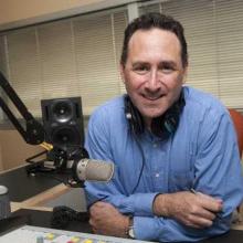 Ben sitting at microphone in studio